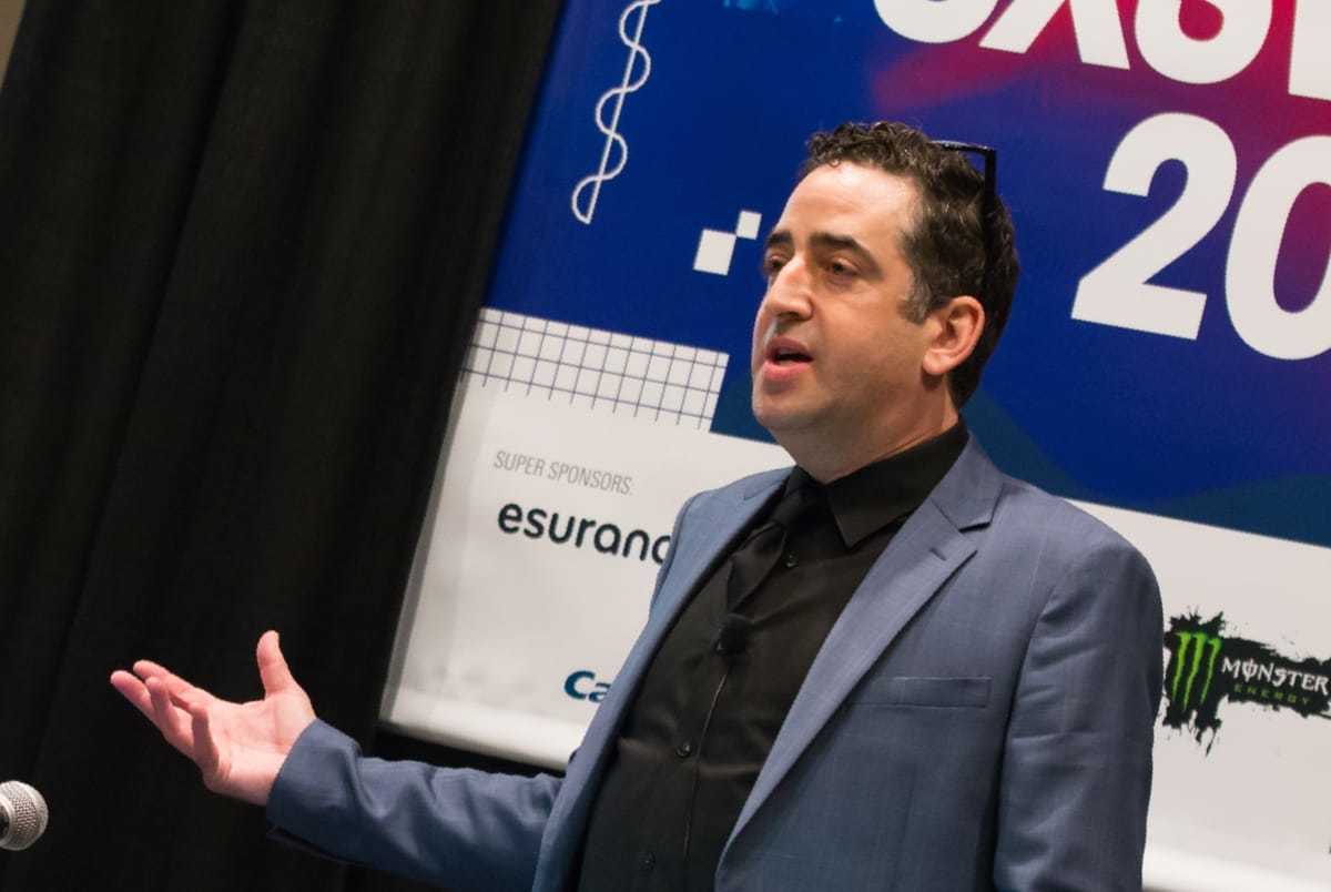 Gil Gershoni at South by Southwest. He is wearing a blue suit, with a black shirt and tie.